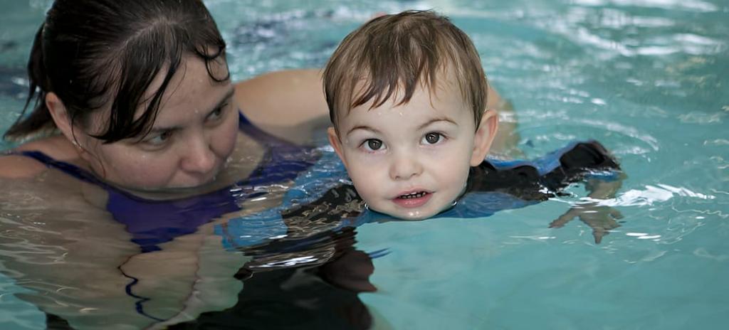 Mother teaching her son to swim