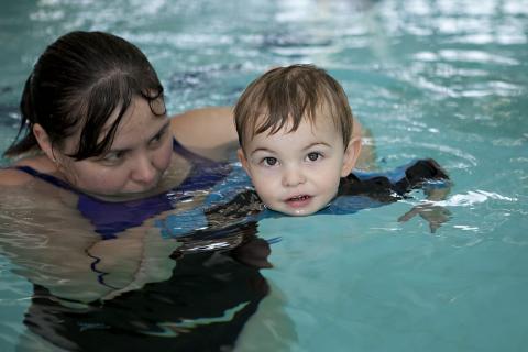 Mother teaching her son to swim